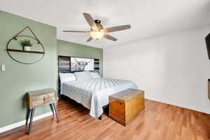 Bedroom featuring ceiling fan, LVP flooring, and a textured ceiling