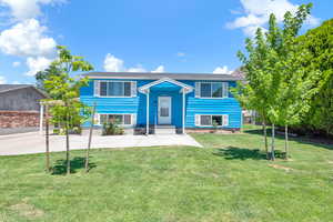 Exterior space featuring a lawn, landscaping, carport