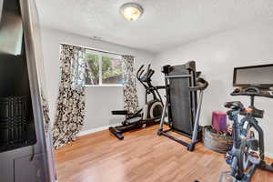 Workout room with a textured ceiling and LVP floors