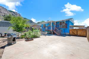 Rear view of house with a mountain view and a patio