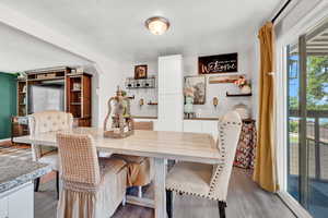 Dining area featuring light LVP floors, built in storage bar area