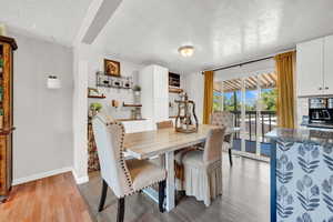 Dining area featuring light LVP flooring, walk out to deck