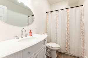 Bathroom 2 featuring wood-type flooring, toilet, walk in shower, and vanity