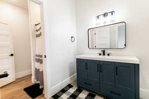 Bathroom 4 with hardwood / wood-style flooring and vanity