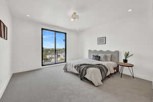 Bedroom featuring light carpet