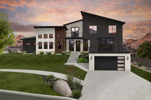 Modern home with a balcony, a garage, a mountain view, and a yard