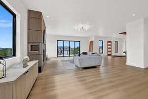 Living room with light wood-type flooring and a healthy amount of sunlight