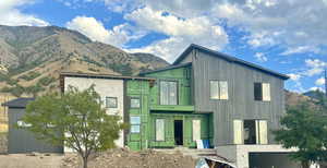 Front of property- front entrance, deck and garage.