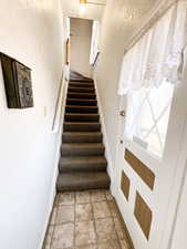 Stairs to apartment and east exterior door.