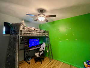 Bedroom with ceiling fan and light wood-type flooring