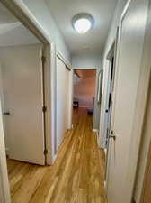 Corridor with light wood-type flooring