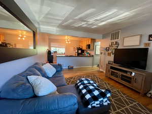 Living room featuring hardwood / wood-style floors and a chandelier