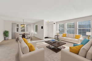 Carpeted living room with a chandelier