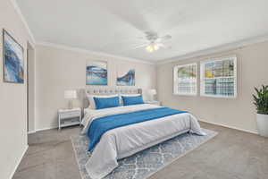 Digitally staged Bedroom with carpet, ceiling fan, and crown molding