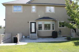 Back of house featuring a patio area and a yard