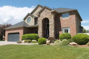 View of front facade with a garage and a front yard