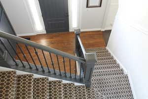 Stairway with hardwood / wood-style flooring