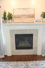 Interior details featuring hardwood / wood-style floors and a tile fireplace