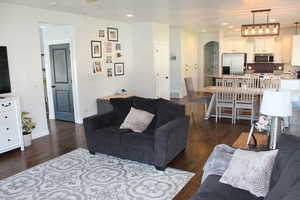 Living room featuring dark hardwood / wood-style flooring and sink