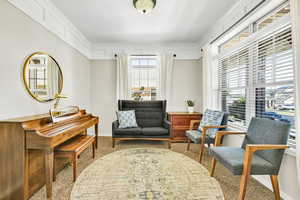 Sitting room featuring carpet and crown molding