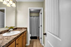 Bathroom featuring tile patterned floors, toilet, and vanity