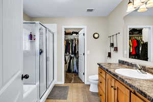 Full bathroom featuring separate shower and tub, toilet, tile patterned floors, and vanity