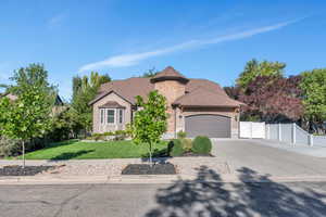 View of front of house featuring a garage and a front yard