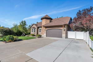 View of front of house with a garage and a front yard