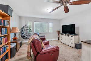 Living room featuring light hardwood / wood-style flooring and ceiling fan