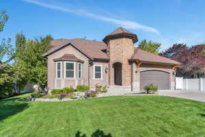 View of front of property with a garage and a front yard