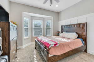 Carpeted bedroom with ceiling fan