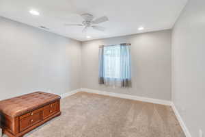 Spare room with ceiling fan and light carpet