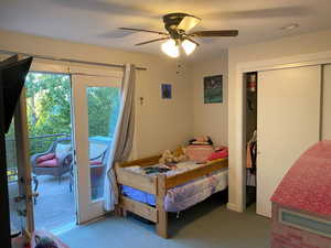 Bedroom with ceiling fan, a closet, carpet floors, and access to exterior