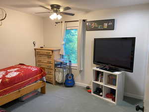 Bedroom with ceiling fan and carpet floors