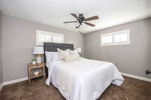 Bedroom #1 with carpet flooring and ceiling fan.