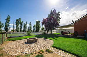 View of yard with an outdoor fire pit.