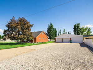 Front view of property with a garage and gravel RV parking