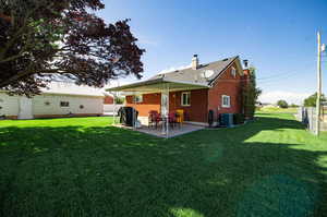 Cozy covered patio and immaculate landscaping with irrigation.