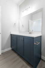 Bathroom with vanity and hardwood / wood-style floors