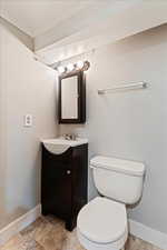 Bathroom with tile patterned floors, vanity, and toilet