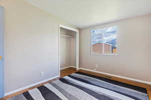 Unfurnished bedroom with a closet and wood-type flooring