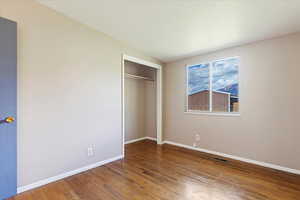 Unfurnished bedroom featuring a closet and wood-type flooring