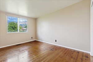 Unfurnished room featuring hardwood / wood-style floors