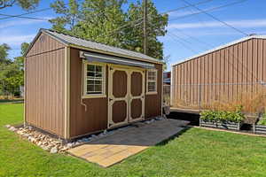 View of outdoor structure with a lawn