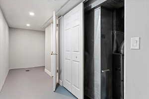 Hallway featuring concrete flooring