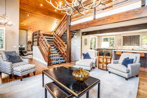 Living room with light hardwood / wood-style floors and a chandelier