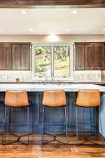 Kitchen with light hardwood / wood-style floors, plenty of natural light, and decorative backsplash