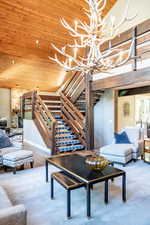 Living room with wooden ceiling, hardwood / wood-style flooring, an inviting chandelier, and french doors