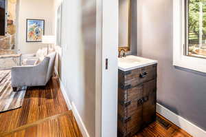 Interior space with sink and dark hardwood / wood-style floors