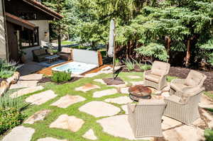 View of yard featuring a patio area and an outdoor living space with a fire pit